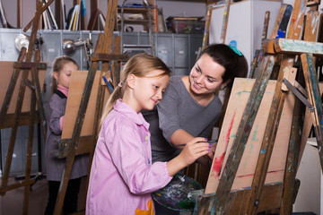 Teacher helping teenage students