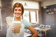 © vectorfusionart - Composite image of waitress pointing away a cup of coffee