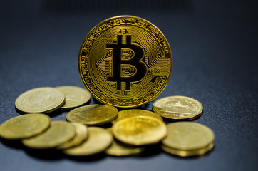 Photo of golden bitcoin (new virtual currency) with Gold coins.