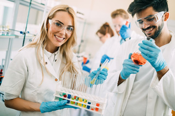 Young students of chemistry working in laboratory