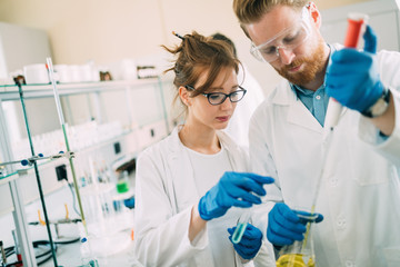 young students of chemistry working in laboratory