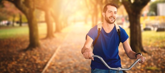 Poster - Composite image of young man riding bicycle