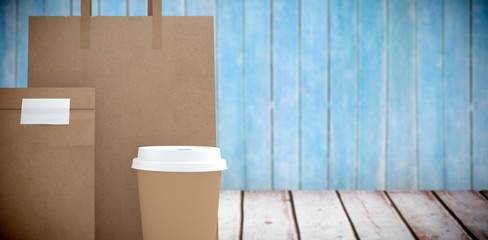 Poster - Composite image of disposable coffee cup and parcel bag 