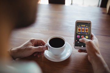 Poster - Composite image of slot machine app on mobile display