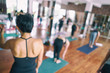 © Somkiat - Group women asian doing stretching yoga hot exercises with instructor in studio