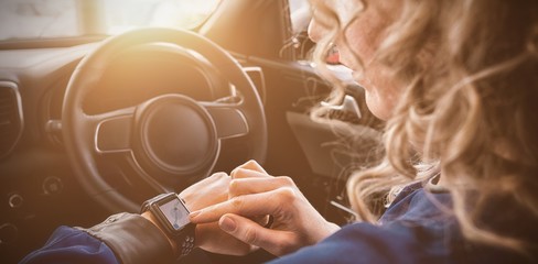 Poster - Close up of woman using smart watch in car
