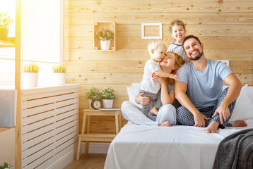 Sticker -  happy family mother father and children daughter and son in bed