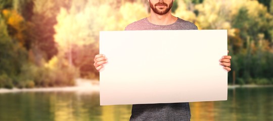 Sticker - Composite image of midsection of young man holding cardboard