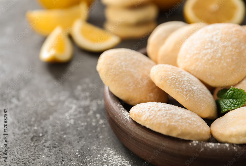 Plate with homemade lemon cookies on table