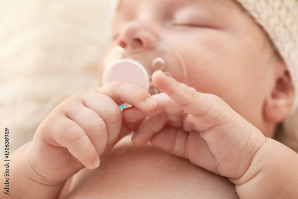 Cute little baby with pacifier sleeping at home, closeup