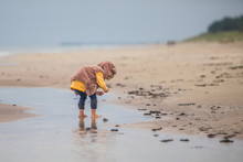Girl Playing In Water In Empty Beach 