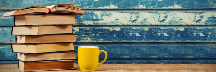 Poster - Stack of books with cup on table