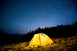 © MIRACLE MOMENTS - Glowing camping tent in the mountain forest under a starry sky