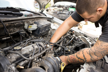 Young mechanic working on a car