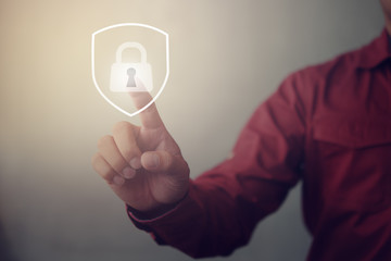 Leinwandbilder - Person touching virtual button a shield with a lock symbol, concept about security, cybersecurity and protection against dangers