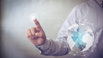 Poster - Businessman hand touching virtual button on Earth map point with network connection, international meaning
