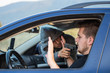 © HappyLenses - A thief, a criminal with a pistol threat, tries to steal a car, sits at the passenger's seat and holds a pointed gun in the driver's car