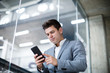 © ReeldealHD images - Businessman using smartphone in an office