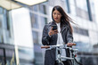 © ReeldealHD images - Businesswoman cycling to work using smartphone