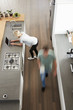 © Monkey Business - Overhead View Of Busy Couple In Modern Kitchen
