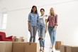 © Monkey Business - Portrait Of Three Female Friends Moving Into New Home Together
