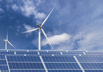 solar panels and wind turbines generating electricity in power station green energy renewable with blue sky background 