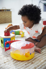 Wall Mural - Cute Baby Girl Having Fun In Playroom With Toys