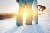 Closeup snowboarder at ski slope with snowboard