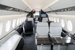 Modern business jet aircraft interior cabin view.