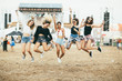 Friends jumping together on music festival