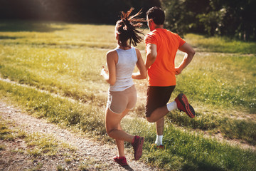 Wall Mural - Happy couple running and jogging together