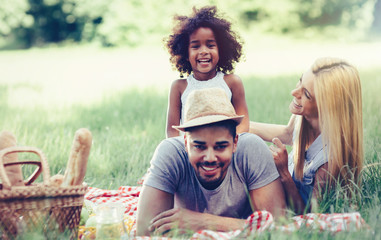 Wall Mural - Family having fun picnicing in nature