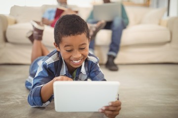 Wall Mural - Boy using digital tablet in living room