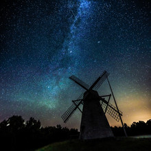 Starry Sky Above An Old Wooden Windmill