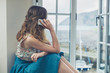 © LoloStock - Woman using her phone by window of country house