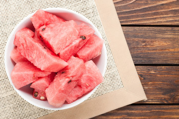 watermelon slices in plate on cloth textured background