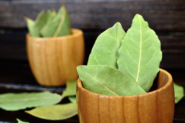 bay leaf in bowl on wooden table