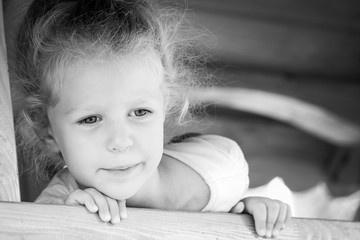 Little happy girl on the playground. Black and white series.