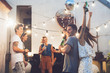 © Lumina/Stocksy - Group of Friends at Rooftop Party.