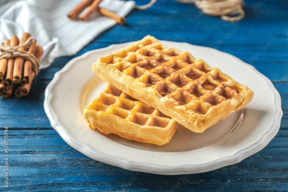 Tasty homemade waffles with honey on white plate