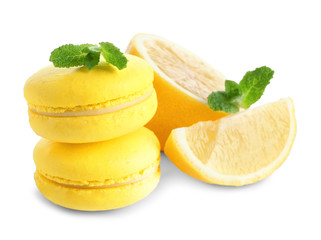 Wall Mural - Lemon macarons with sliced fruit and mint leaves on white background