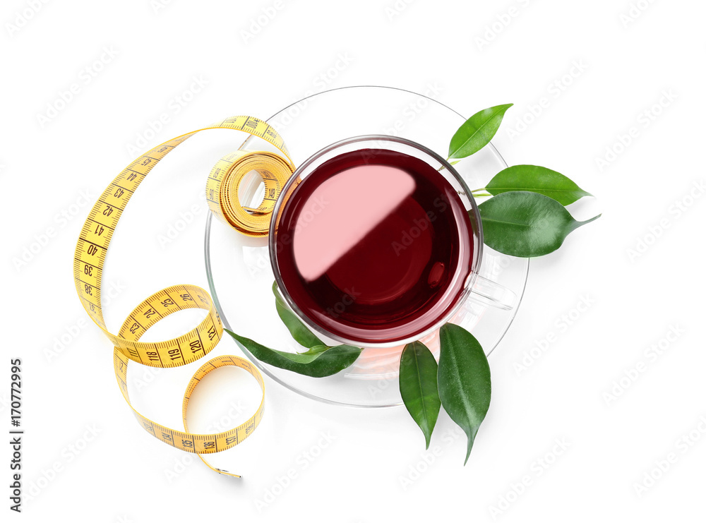 Cup of tea and measuring tape on white background. Weight loss concept