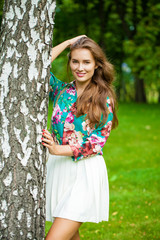 Wall Mural - Young brunette woman in white skirt