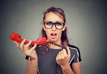 Shocked young woman receiving bad news on the phone