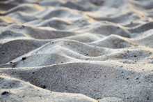 Texture Of Waves Of Gray Sand. Selective Focus.