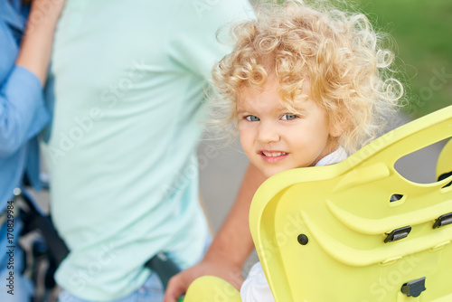 Shot Of A Cute Little Blonde Haired Baby Girl Sitting In A Baby