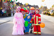 © famveldman - Kids and parents on Halloween trick or treat