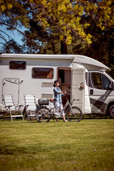 Wall Mural - Woman on electric bike resting at the campsite