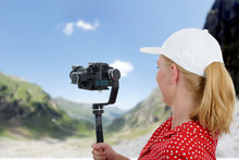 Woman Videographer Using Steady Cam,
