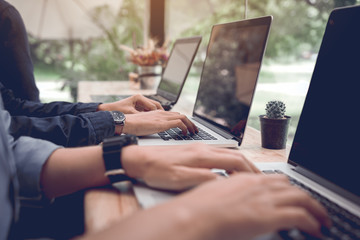 Group of people typing keyboard laptop and working on cafe with co-working space concept.